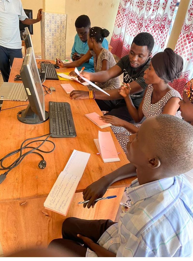 Young people learning together at computers